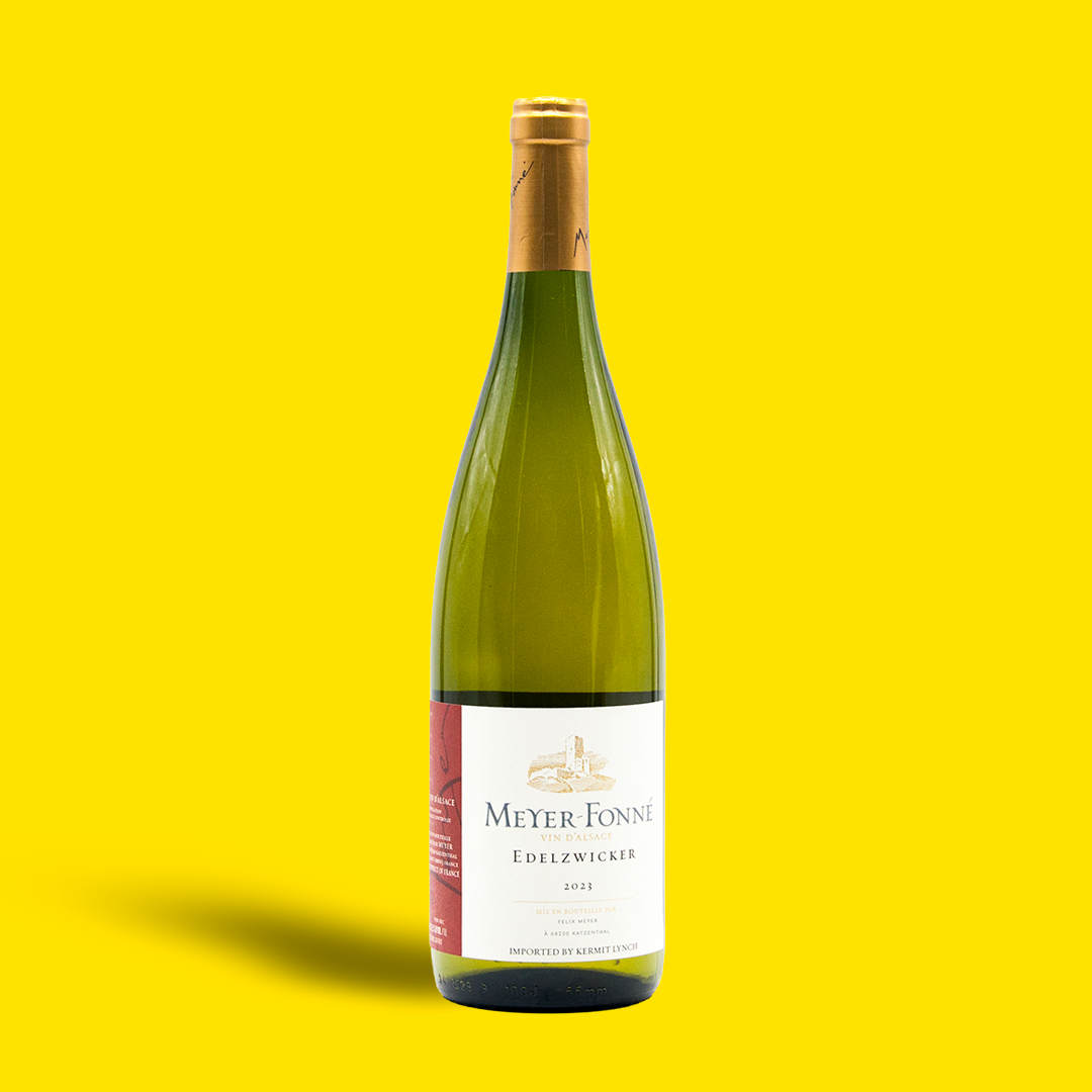 Green wine bottle with a gold cap on a yellow background