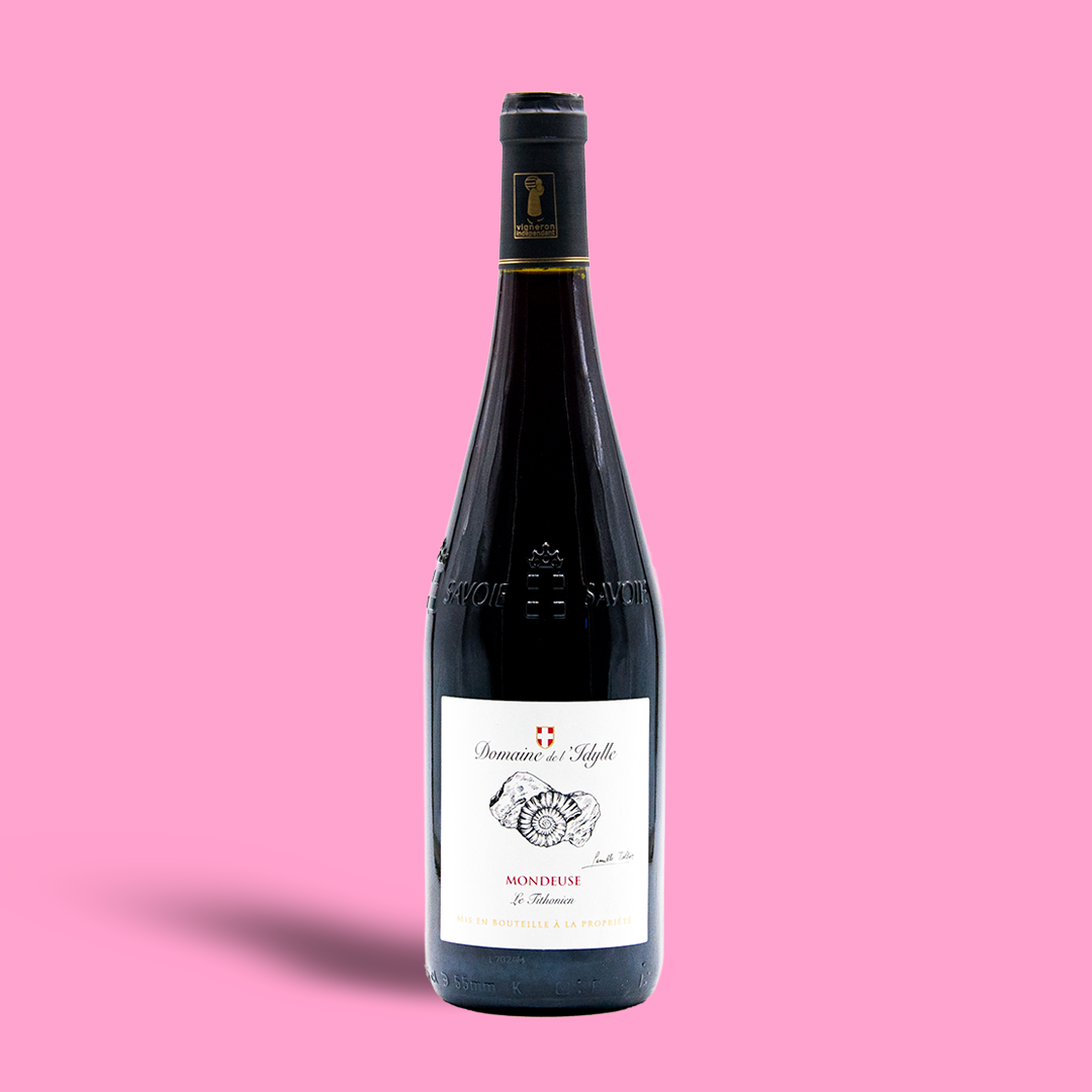 Wine bottle with a label on a pink background